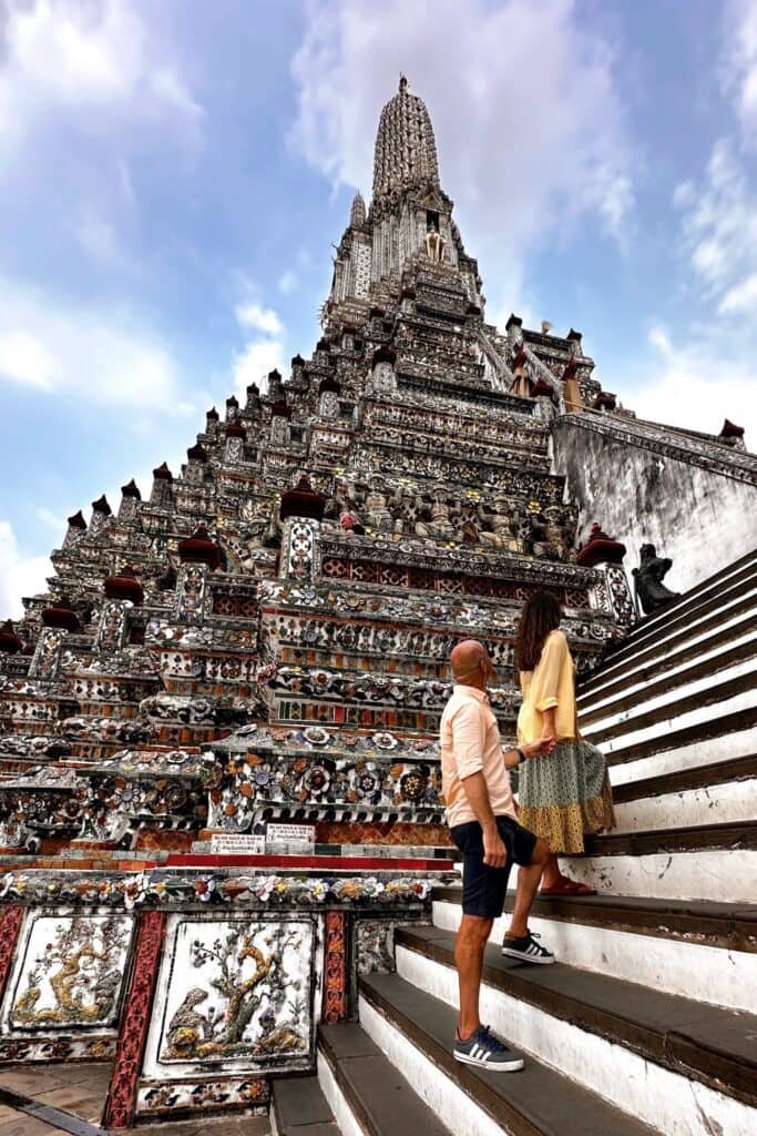 Wat Arun’da dik merdivenlerden prang yönüne çıkan çift ve mozaik detaylar
