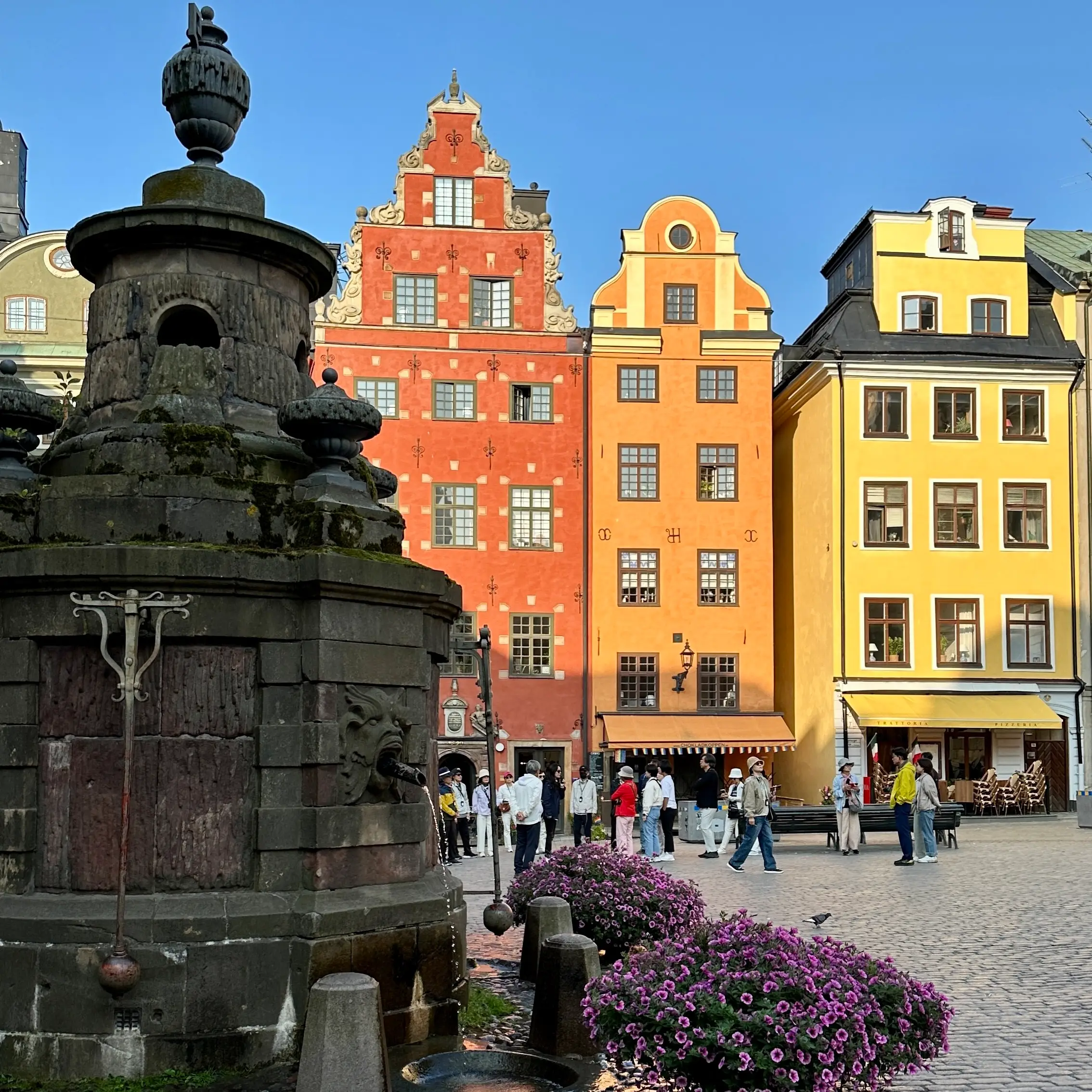 Stockholm Gamla Stan Stortorget Meydanı’nda renkli tarihi binalar ve çeşme, İsveç gezi rehberi